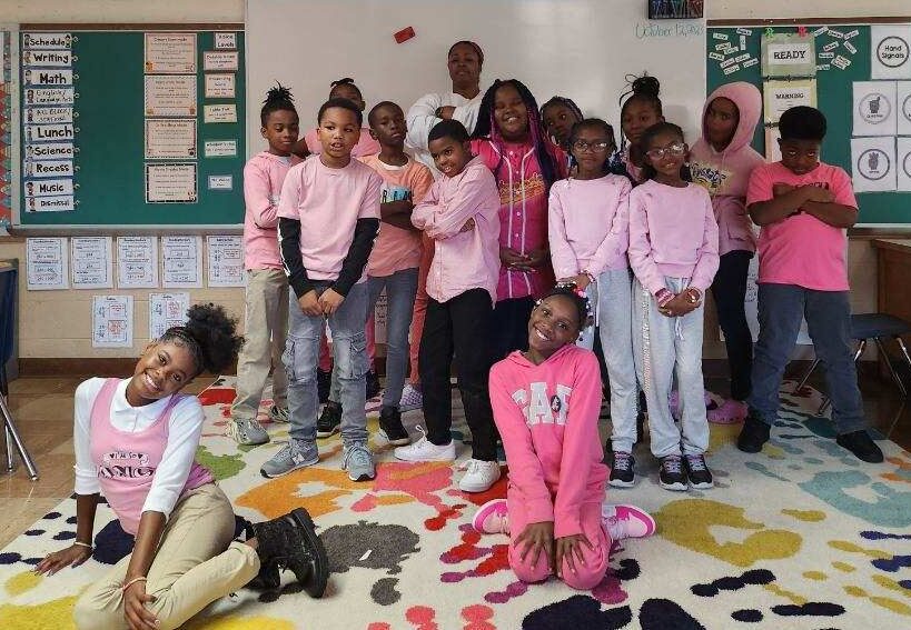 group of students wearing pink